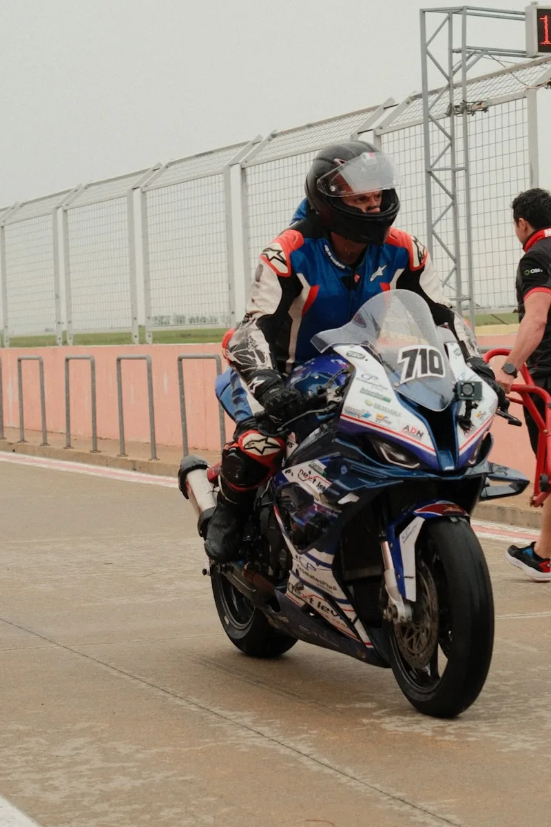 Motorcycle Riding Gloves Racer on a motorcycle at the starting line.