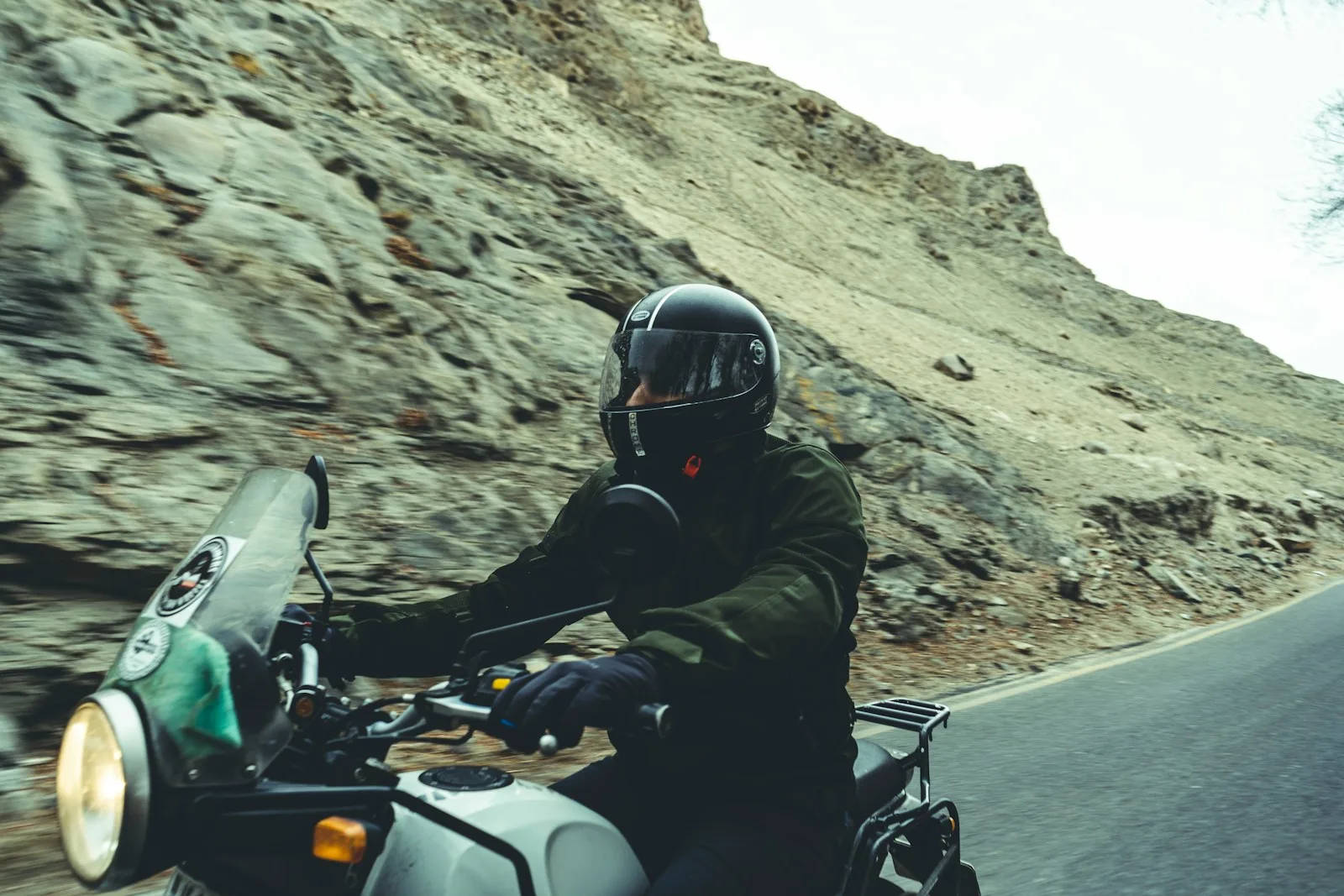 Motorcycle Riding Helmets man in black helmet riding on white and black motorcycle during daytime