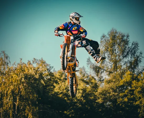 Motorcycling Blogs & Reviews a man riding a dirt bike through the air