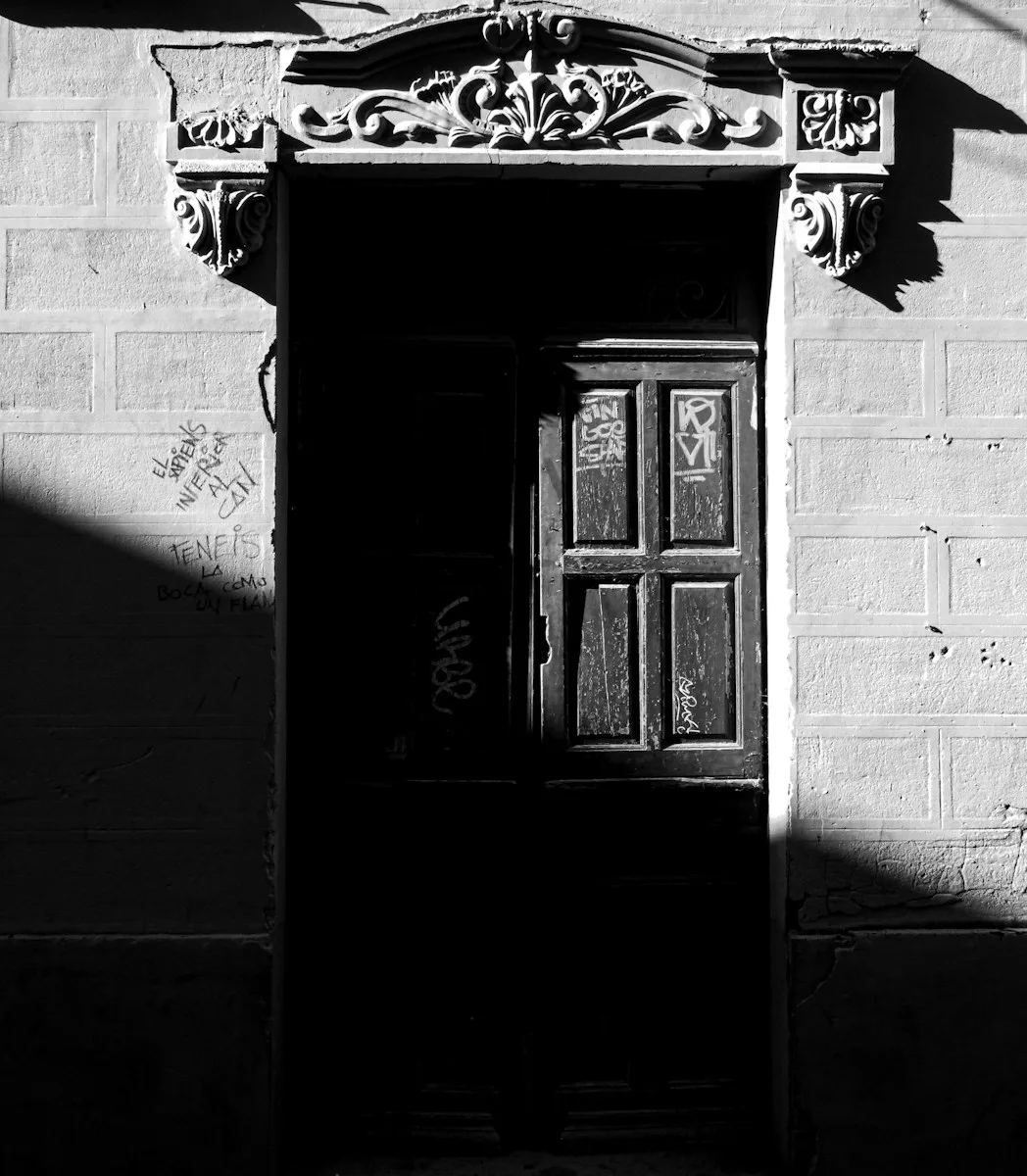 about us A black and white photo of a doorway