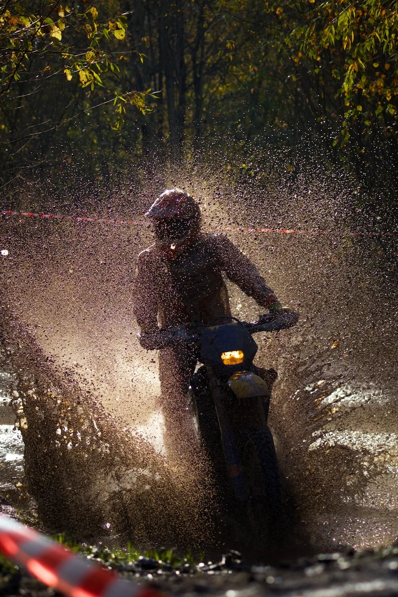 Motorcycle Riding Gloves a person riding a motorcycle in the rain